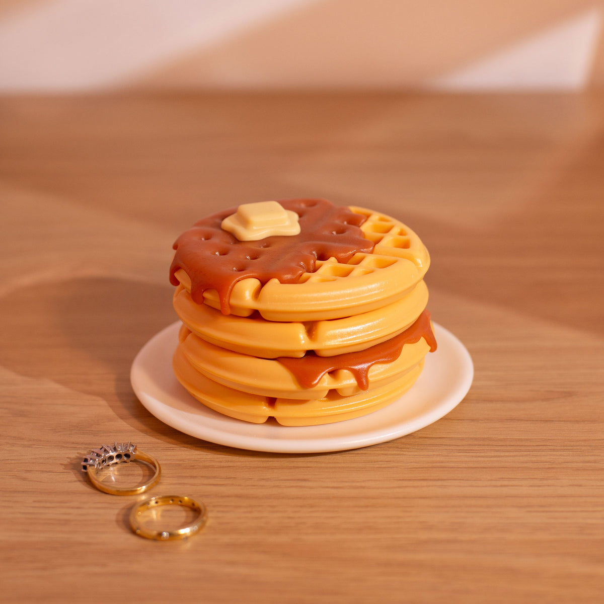 Handmade waffle trinket dish used as a small jewelry box on wooden surface