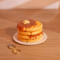 Handmade waffle trinket dish used as a small jewelry box on wooden surface