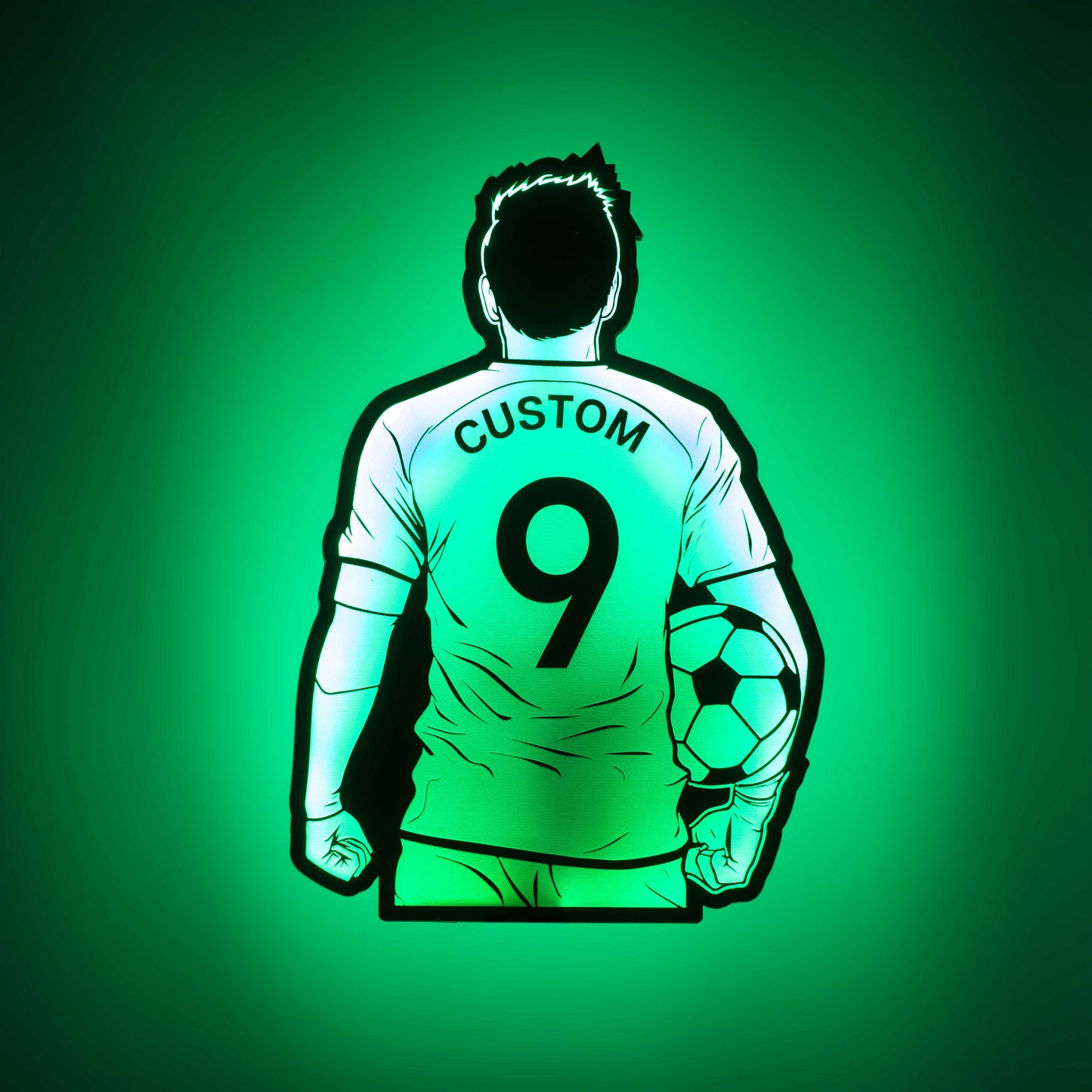 a 3d wall mounted acrylic light, back-lit by  multi-color led lights, featuring a cartoon style illustration of soccer player holding a soccer ball under his arm, view from behind showing the back of the soccer players jersey. The text and number on the back of the jersey can be personalised.
