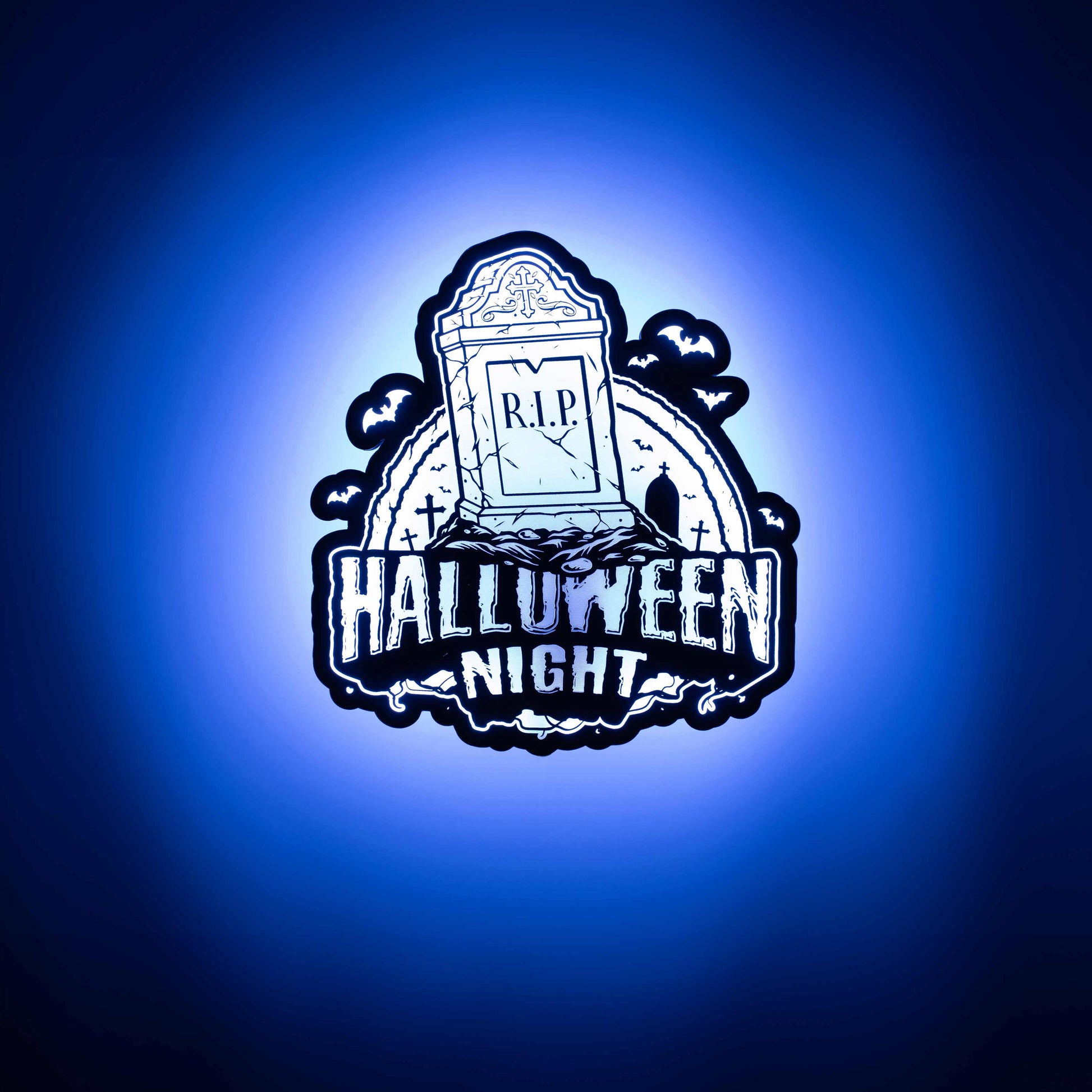 a 3d wall mounted acrylic light, backlit by multi-color led lights, featuring a cartoon style scary halloween themed illustration. A scary tomb stone rises up from a haunted grave yard scene complete with bats and spooky halloween themed text that reads "halloween night".