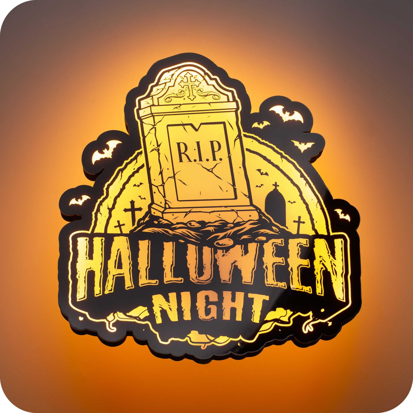 a 3d wall mounted acrylic light, backlit by orange multi-color led lights, featuring a cartoon style scary halloween themed illustration. A scary tomb stone rises up from a haunted grave yard scene complete with bats and spooky halloween themed text that reads "halloween night".