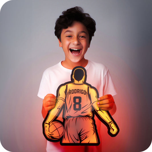 a 3d wall mounted acrylic light, back-lit by multi-color led lights, featuring a cartoon style illustration of a basketball player, view from behind showing the back of the players jersey. The text and number on the back of the jersey can be personalised.