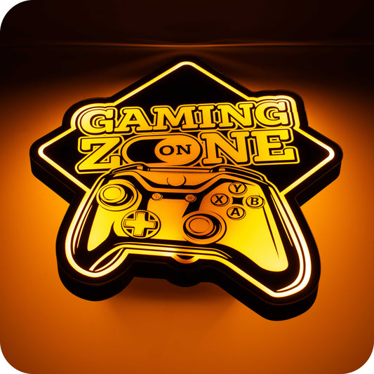 image of a 3d wall mounted acrylic light, back lit by orange led lights, featuring a cartoon style image of a gaming controller. Above the controller sits some epic "gaming zone" text