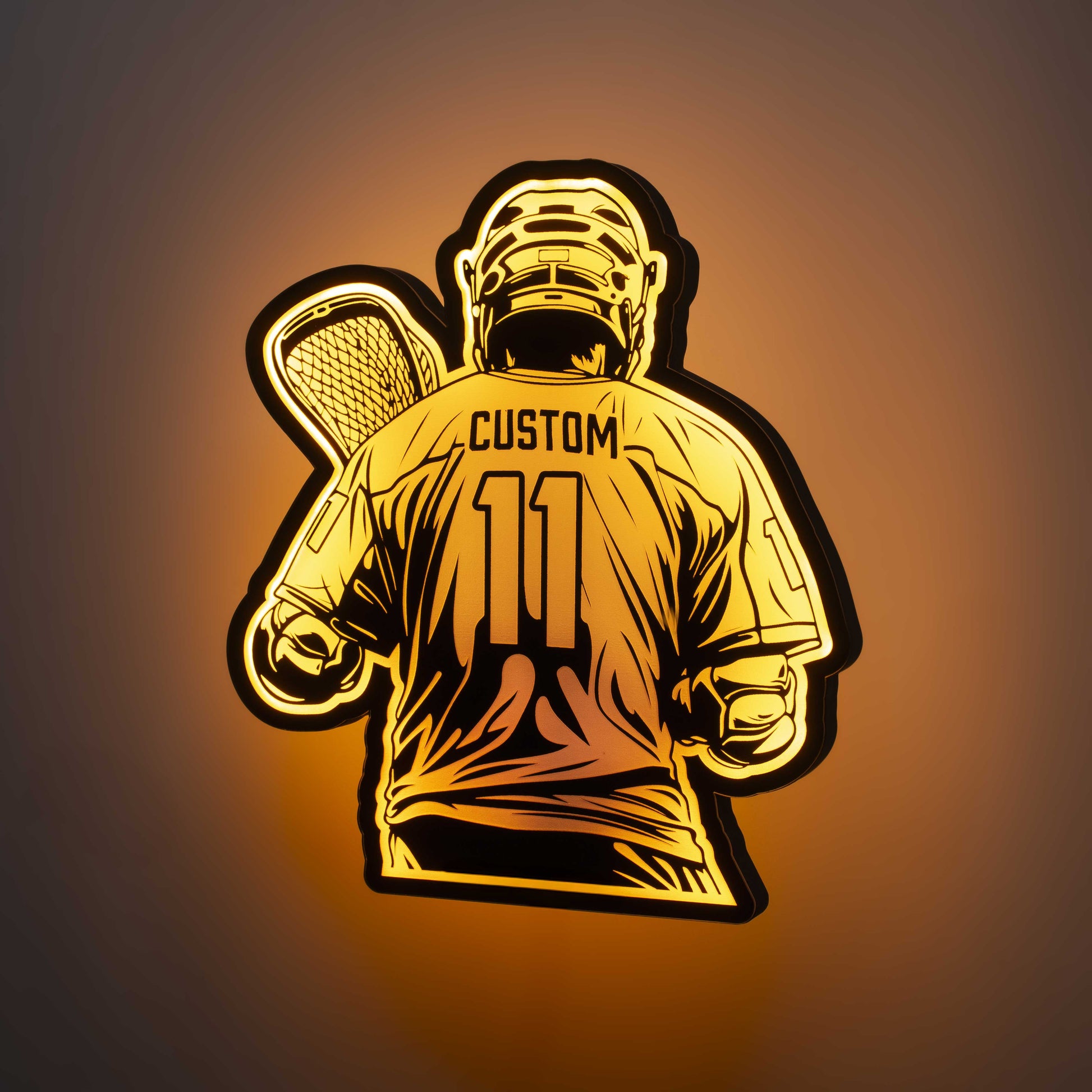 a 3d wall mounted acrylic light, back-lit by  multi-color led lights, featuring a cartoon style illustration of a lacrosse player, view from behind showing the back of the players jersey. The text and number on the back of the jersey can be personalised.